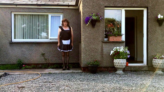 sissy maid neil in his maids uniform outside his house